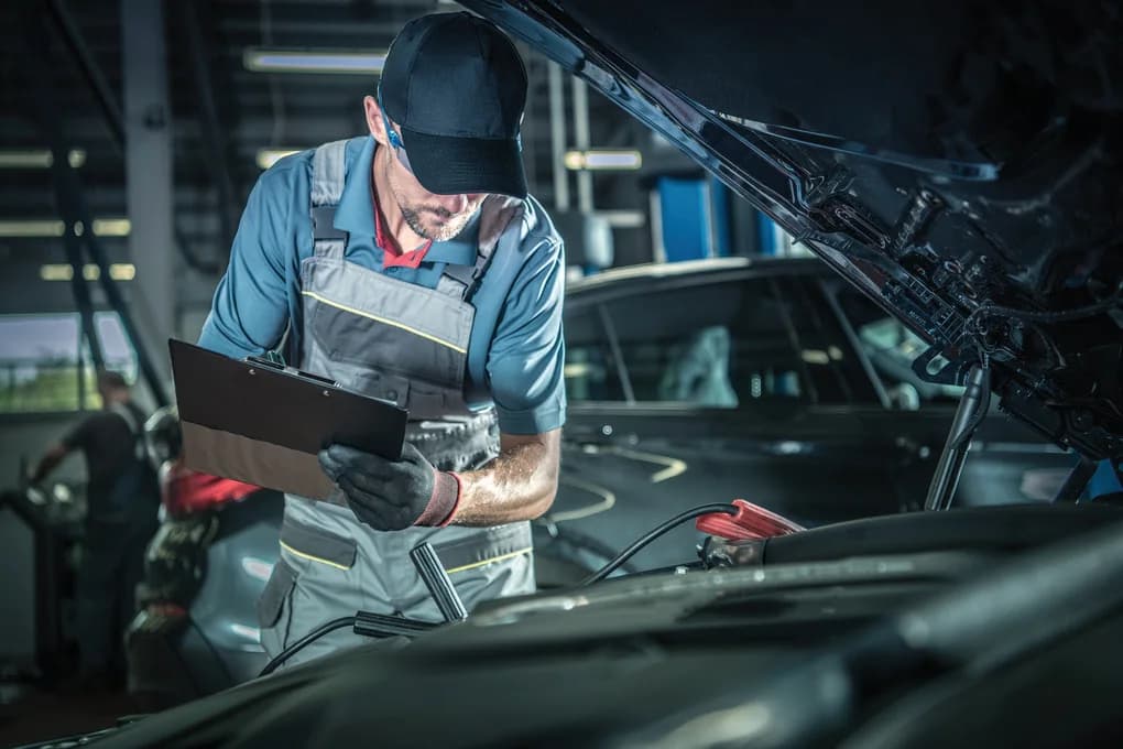 Technician inspecting a vehicle as part of routine equipment maintenance