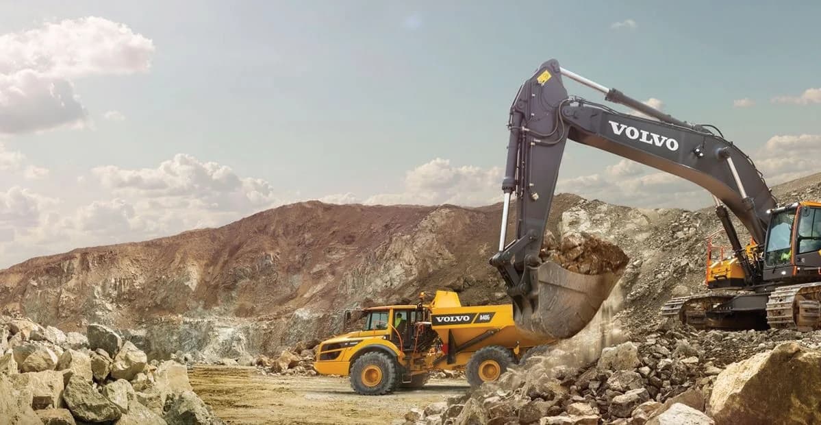 Volvo excavator loading a hauler in a quarry