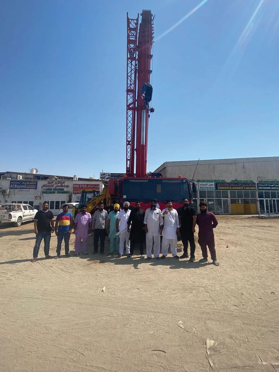 Shergill Transport team in front of a mobile crane in the yard