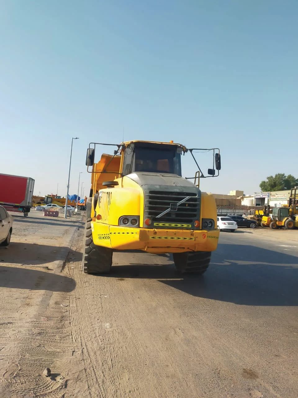 Yellow Volvo articulated dump truck operated by Shergill Transport