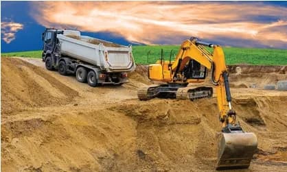 Excavator loading a tipper truck with excavated soil